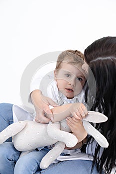 Vertical photo of serious mother holding scared son tight. Children stuttering problem, traumatic experience. Close up