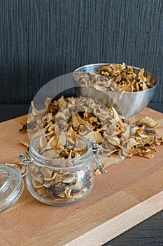 Vertical photo of sliced and dried various mushrooms in three pr