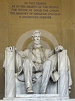 Vertical photo of the statue of Abraham Lincoln sitting on a chair at the National Mall Memorial in Washington DC.