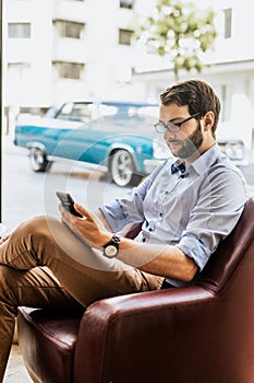 Vertical photo of stylish man working with phone