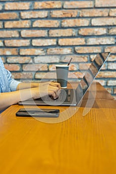 Vertical photo of woman hand typing laptop keyboard on table