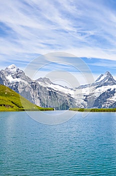 Vertical picture of amazing Bachalpsee near Grindelwald in Swiss Alps photographed with famous mountain peaks Eiger, Jungfrau, and