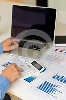 Vertical picture of business people analyzes and discusses and brainstorms data, charts, financial reports in the conceptual work