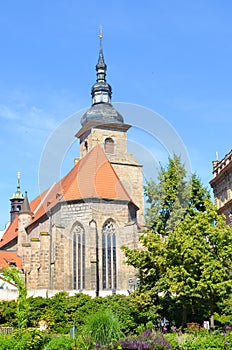 Vertical picture of historical Franciscan Monastery in Plzen, Czech Republic shot from the park in Krizikovy sady. Medieval