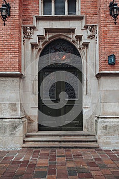 Vertical picture of old architecture door with brick wall outdoor