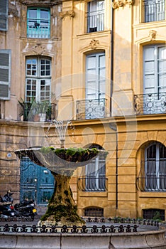 Vertical picture of old fountain on the 17th century Albertas square in Aix-en-Provence, France. Travel tourism destination