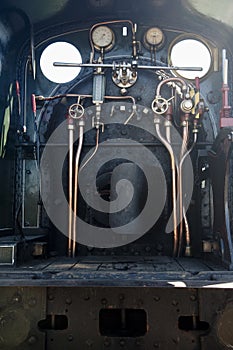 Vertical picture of the rusty machine of a train under sunlight in the UK