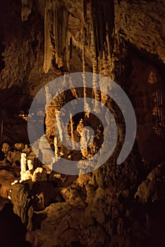 Vertical picture of stalagmites and stalactites in Aven dOrgnac cavern in Ardeche departement, France. Famous speleology travel