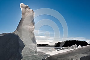 Vertical piece of cracked ice with backlight at a