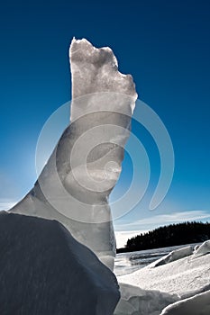 Vertical piece of cracked ice with backlight at a