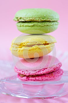 Vertical pile of three colorful french cookies made of almond flour called macarons