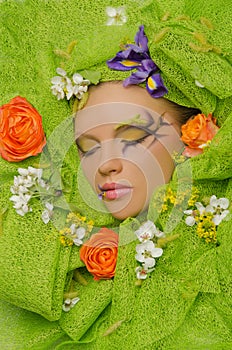 Vertical portrait of beautiful woman in flowers