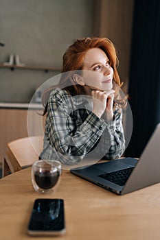 Vertical portrait of cheerful young woman freelancer take break from work, looking away dreaming thinking or future