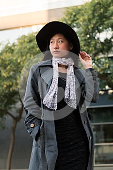 Vertical portrait of a classy asian woman in hat