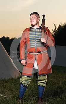 Vertical portrait in full growth of the Slavic soldiers in historic costume