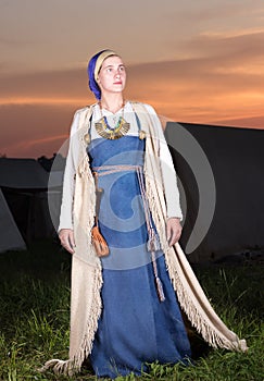 Vertical portrait in full length of a young woman in historical costume