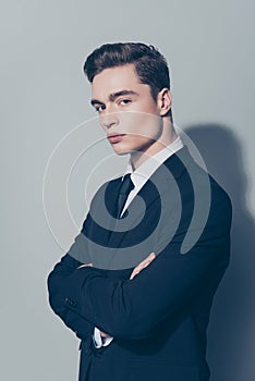 Vertical portrait of handsome young thoughtful man standing hal