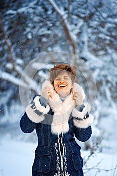 Vertical portrait of joyful Winter Woman with short haircut in Luxury Fur Coat. Beauty Fashion Model Girl in Blue Fox Fur Coat.
