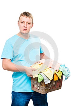 vertical portrait of a man with a basket of clean linen on a white background