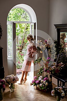 Vertical portrait of a pensive blonde in retro interior