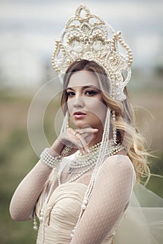 Vertical portrait of a Russian girl in kokoshnik photo