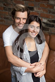 Vertical portrait of smiling attractive young couple looking at