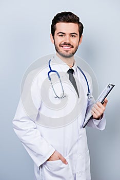 Vertical portrait of successful happy smiling doctor in uniform