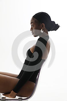 Vertical portrait of young African American woman posing on white wall. Mock-up.