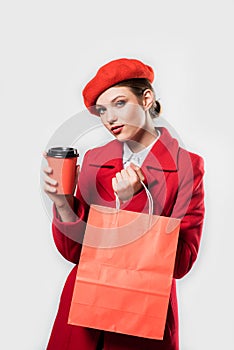 Vertical portrait young beautiful fashionable woman wearing stylish winter red coat, silk scarf, red beret on a white in