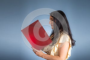 Vertical portrait of young businesswoman, lawyer, showing her business folder