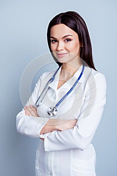 Vertical portrait of young confident female medico standing with