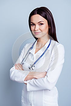 Vertical portrait of young confident female medico standing with photo