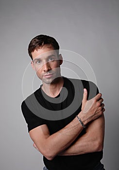 Vertical portrait of young man with serious face expression. White background. photo