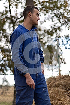 Vertical portrait of a young rancher on his work day