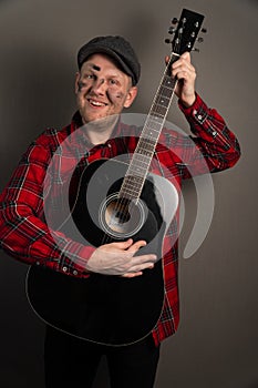 Vertical portrait of a young street musician who is upset. earning concept on the city streets