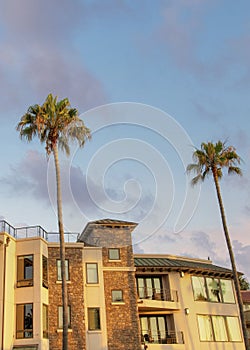 Vertical Puffy clouds at sunset Oceanside building rentals in a low angle view at California
