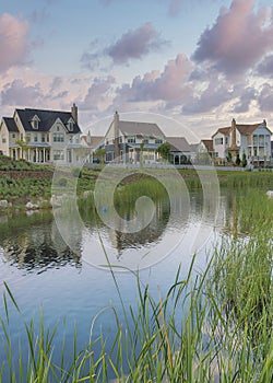 Vertical Puffy clouds at sunset Oquirrh Lake with a reflection of the residential houses at Dayb photo