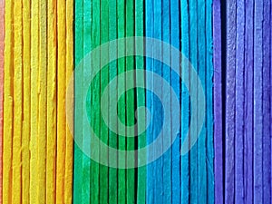 vertical rainbow pattern plank wall background texture for design or stock photo, colourful wooden, orange yellow green blue