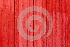 Vertical red weathered wooden plank fence