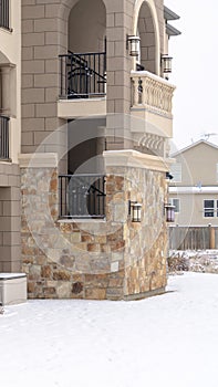 Vertical Residential apartment building facade with snow covered yard in winter