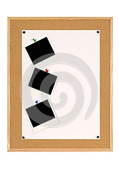 Vertical row of Polaroid photo prints on cork notice board, blank white poster paper, copy space