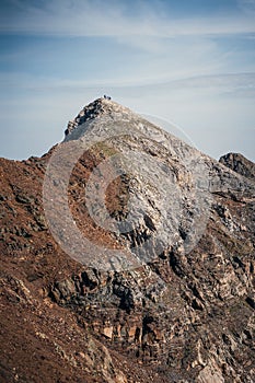 Vertical of a rugged, rocky mountain top captured against the sky