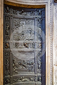 Vertical:Sansovino`s Bronze door of Sacristy inside St. Mark`s Basilica.