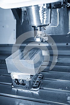 The vertical scene of CNC milling machine rough cutting the injection mold parts by face-mill tools.