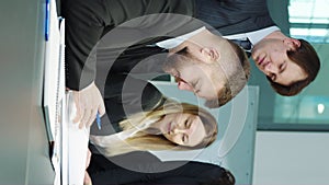 Vertical screen: Business partners signing contract and shaking hands