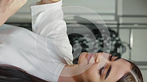 Vertical Screen: Caucasian woman picking outfit at fashion store