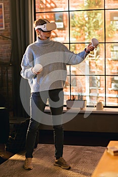 Vertical Screen: Young Female Gamer with Short Hair Having Fun and Playing Virtual Reality Game at