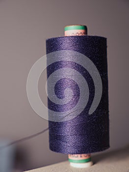 Vertical selective focus of a blue thread spool