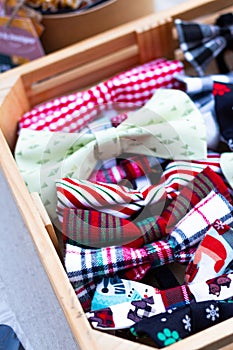 Vertical selective focus of colorful bow ties with different patterns in a wooden box