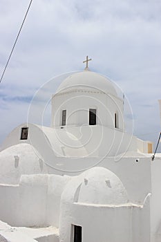 Vertical shot of Agii Anargiri Church in Megalochori village, Santorini Island photo